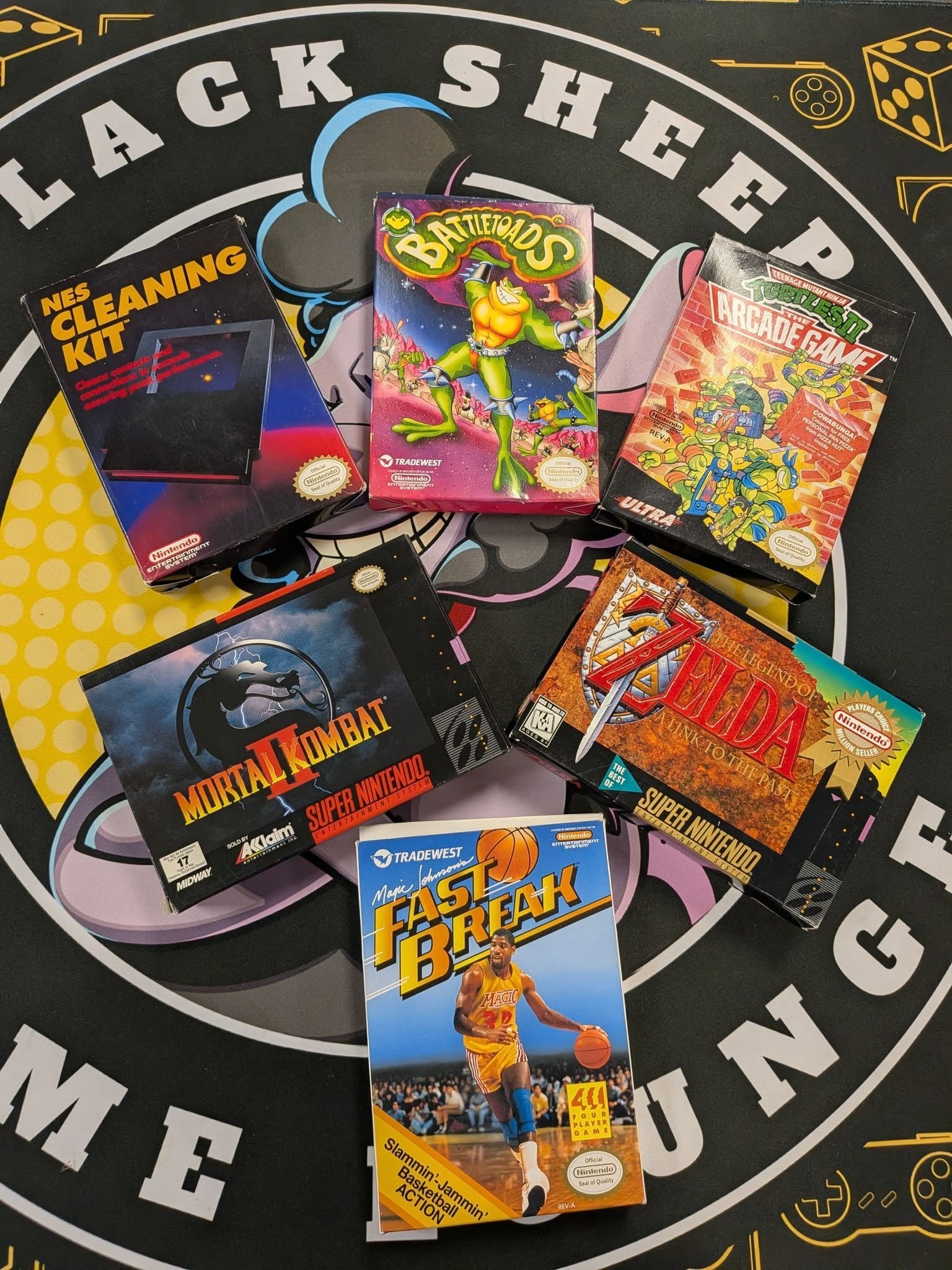 Trading cards on a table with the Black Sheep logo
